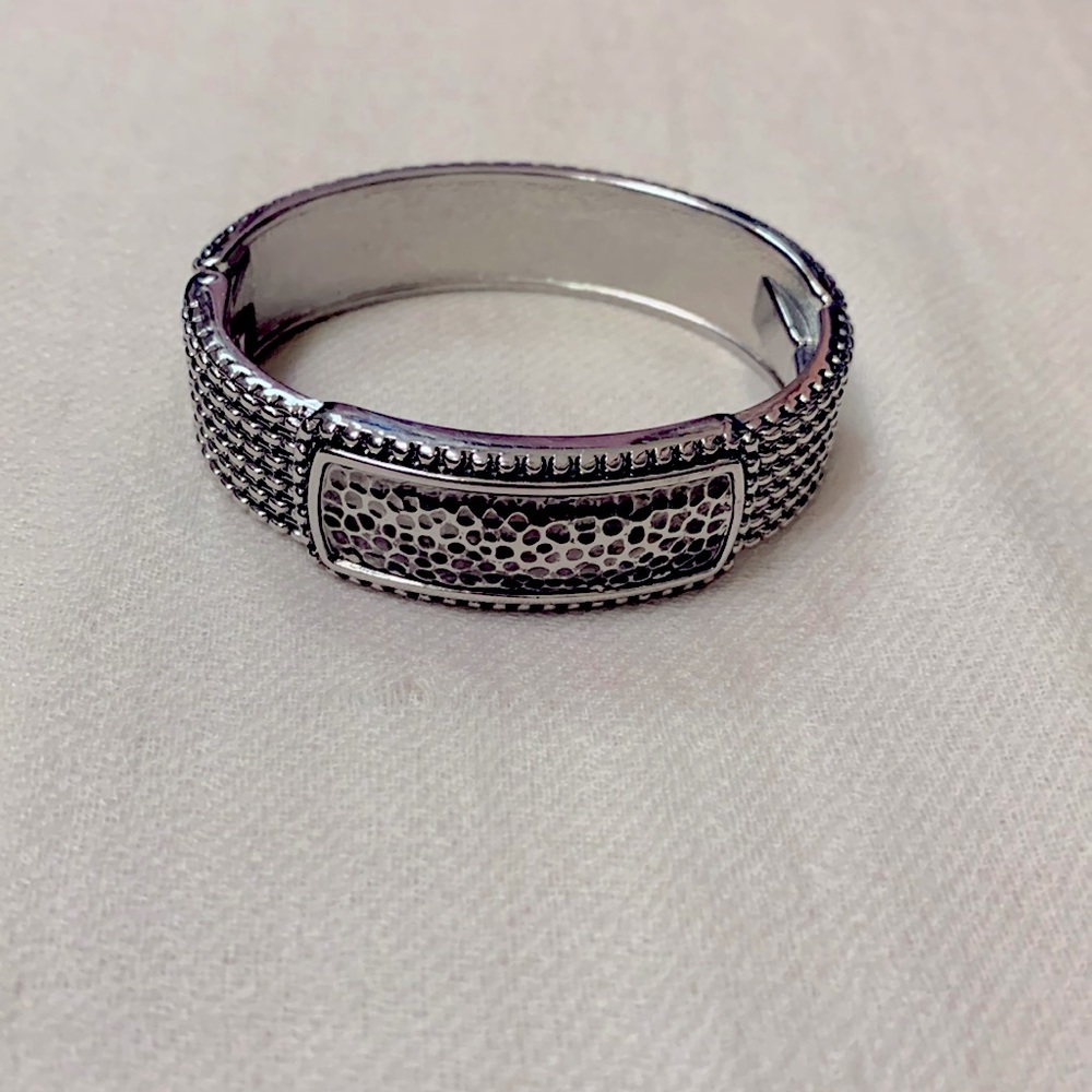 Silver tone hinged bracelet